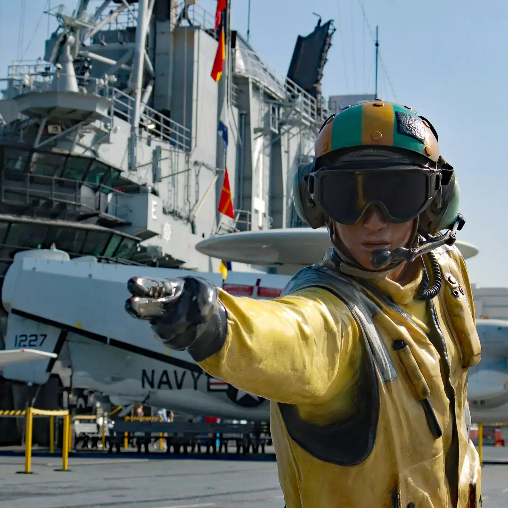 volunteer giving signal to launch jet of the deck at the USS Midway